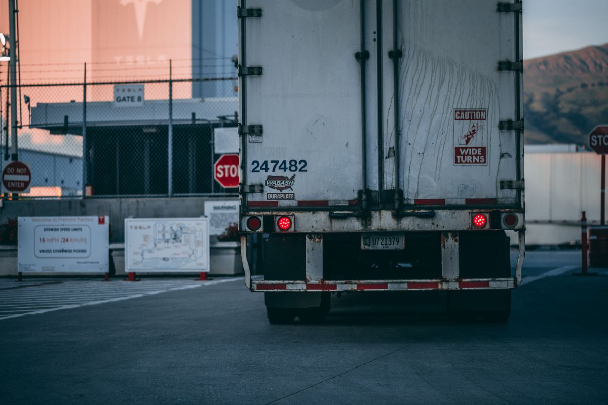 Semi trucks on interstate highway at sunset